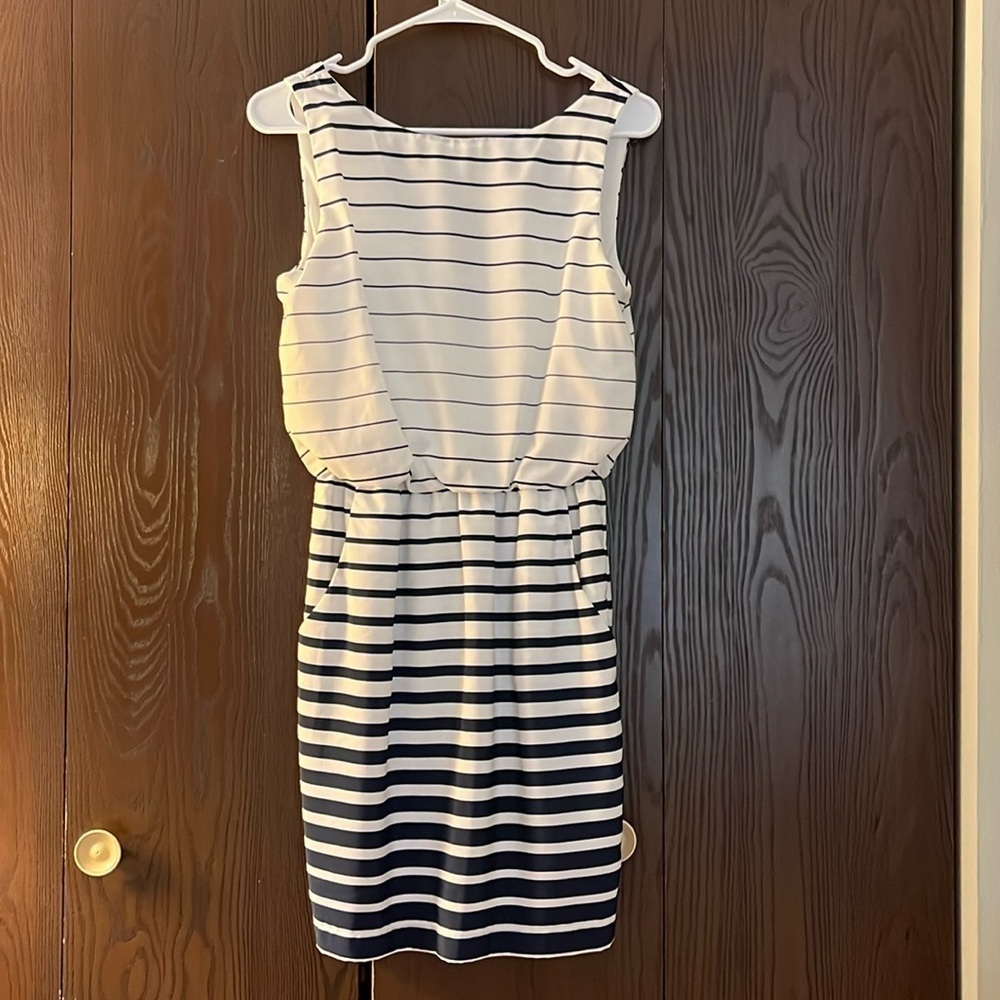 B Smart sleeveless white dress with navy stripes. V neck in the back. Size 4